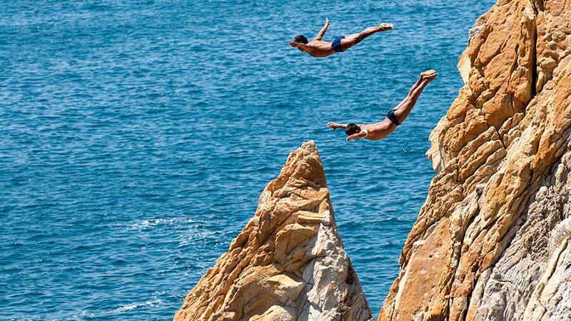 People Jumping Off A Clifff